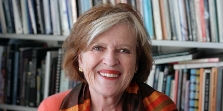 Portrait of Holly Clayson in front of bookshelf