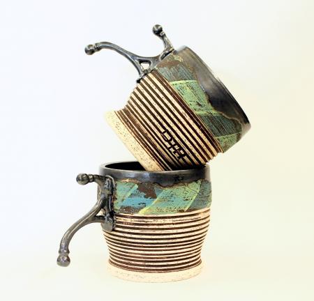 two mugs stacked on top of one another