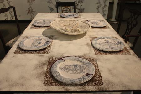 table set with four placemats and sets of tableware