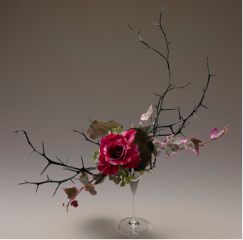 flower arrangement with a rose and branches 