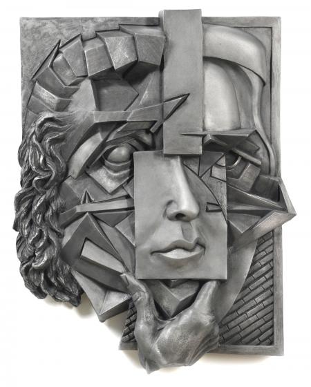 An example of the artists work, a silver sculpture of a face.